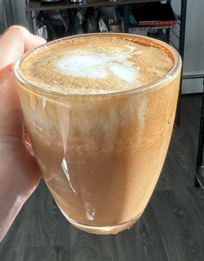 hand holding cup of maple mocha latte