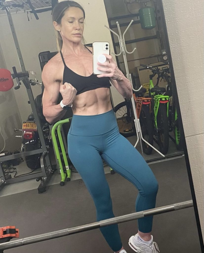 Muscular woman posing in mirror